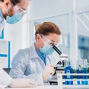 Wissenschaftler schauen durch ein Mikroskop Wissenschaftler schauen durch ein Mikroskop